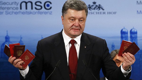 Ukraine's President Petro Poroshenko holds Russian passports to prove the presence of Russian troops in Ukraine as he addresses during the 51st Munich Security Conference at the'Bayerischer Hof' hotel in Munich February 7, 2015. (Reuters/Michael Dalder)