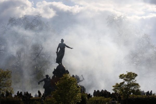 A cloud of tear gas is seen around the statue of the Place de la Nation during clashes between youths and police during a demonstration against the French labour law proposal in Paris, France, as part of a nationwide labor reform protests and strikes, April 28, 2016. REUTERS/Philippe Wojazer TPX IMAGES OF THE DAY